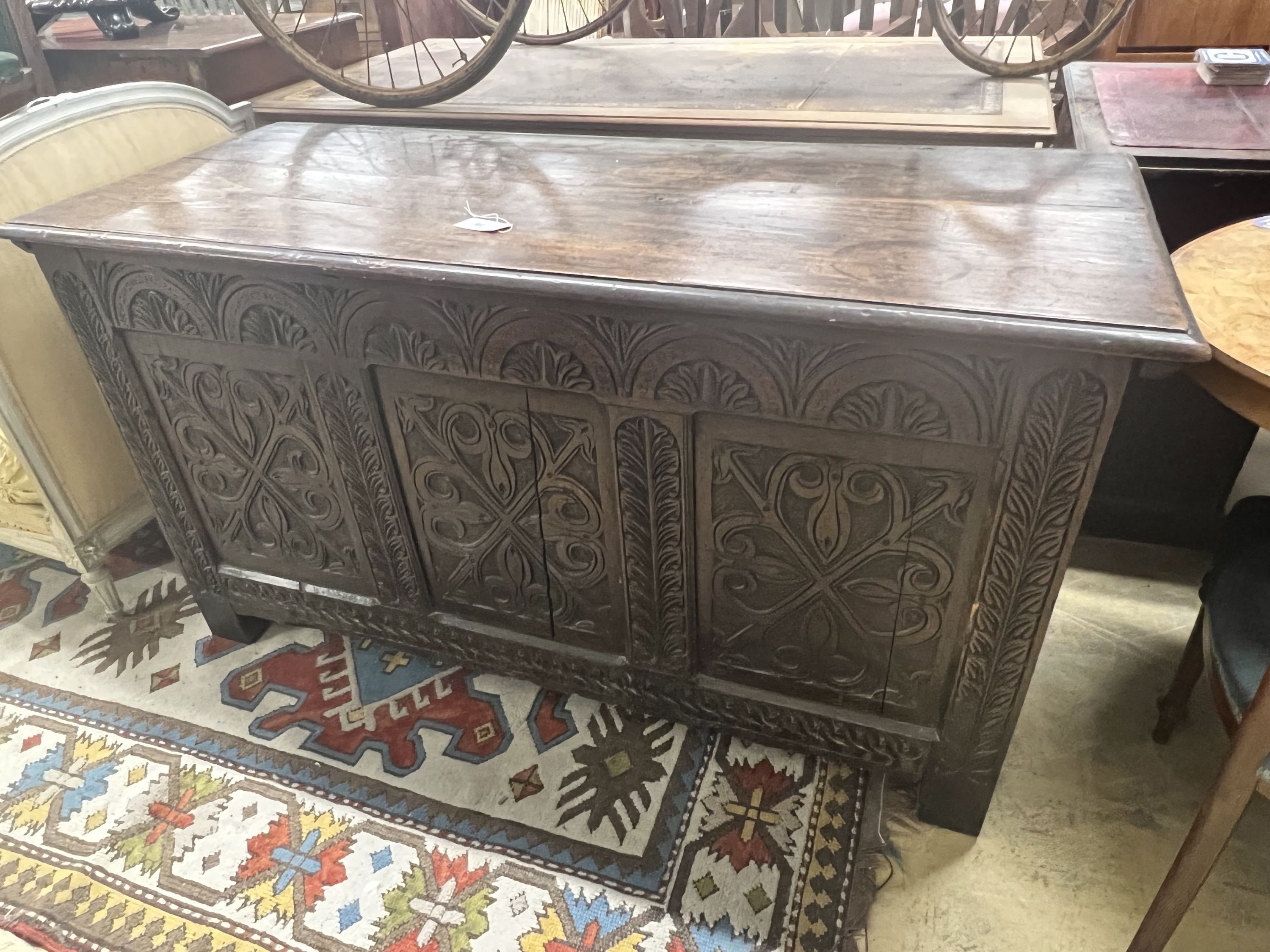 A large 18th century carved oak coffer, width 143cm depth 59cm height 77cm